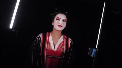 Vintage geisha portrait in dramatic studio lighting. Smiling Japanese woman. Video stock 337504654