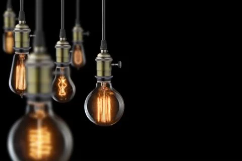 Vintage glowing light bulbs on black background Stock Photos