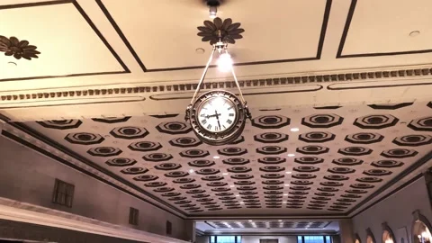 A vintage gold-plated clock fixed to the ceiling in an old hotel Stock Footage 144323669