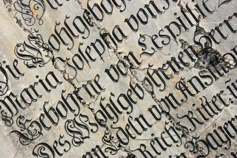 Vintage gothic script on a tomb. Mariendom church wall in Munich, Germany. 库存照片