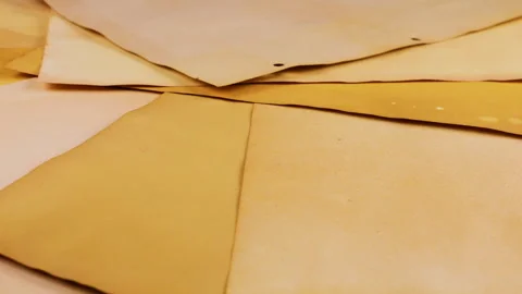 Vintage handmade paper sheets in yellow and brown hues rotating gently.  Stock-Footage 330257532