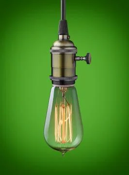 Vintage hanging light bulb over green background Stock Photos