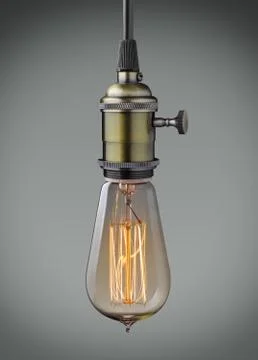 Vintage hanging light bulb over gray background Stock Photos