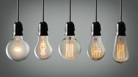 Vintage hanging light bulbs over gray background Stock Photos