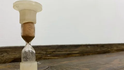 Vintage hourglass on the table   Stock Footage 130028947