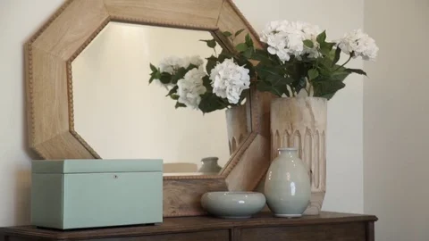 Vintage interior with mirror and a table with a vase and flovers. Stock Footage 77023011
