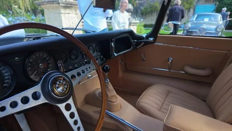 Vintage Jaguar E-Type Roadster interior with leather seats and classic Video stock 323896708