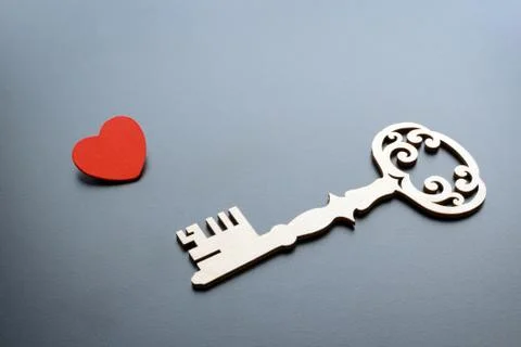 Vintage key with red heart on grey background Stock Photos