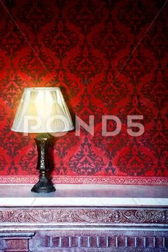Vintage lamp on a retro fireplace toned image Stock-Fotos