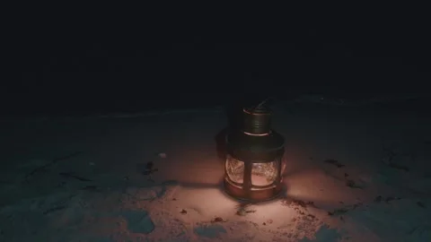 Vintage Lantern casting a soft glow on beach sand at night, creating a peaceful 스톡 동영상 278089538