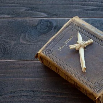 Vintage Leather Bible with Grass Cross on wood table Stock Photos