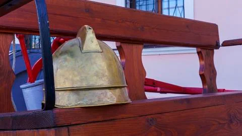 Vintage leather fireman helmet on wall background. Fire fighting concept. Stock Photos