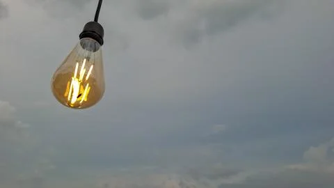 Vintage LED String Light Bulb Glowing at Beach Cafe Stock Photos