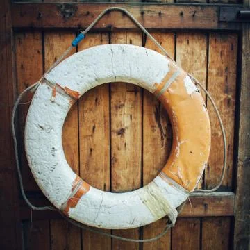 Vintage Lifebuoy Hanging On A Rustic Wooden Wall With Copy Space Stock Photos