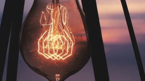Vintage light bulb illuminates Stock Footage 85187429