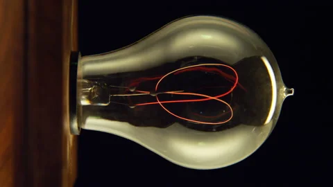 Vintage lightbulb turning on Stock Footage 146413311