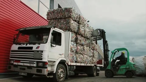 Vintage Loader work at recycling factory with paper and bottles Stock Footage 91331387