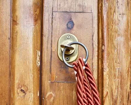 Vintage locks in brown solid wood door closeup with red cord Stock Photos