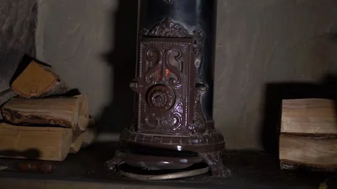 Vintage log burner surrounded by logs in hearth Stock Footage 149058317