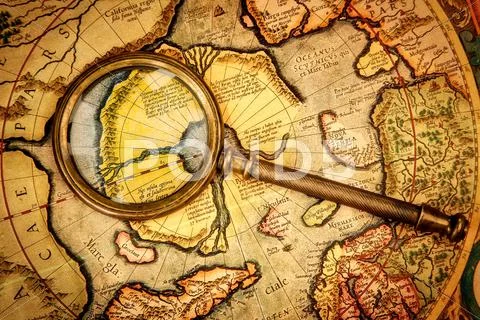 Vintage magnifying glass lies on the ancient map of the north pole (also hype Stock Photos