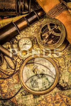 Vintage magnifying glass lies on an ancient world map Stock Photos