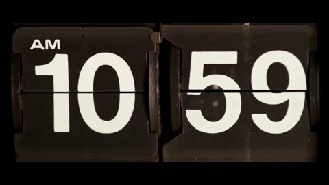 Vintage mechanical clock flips from ten fifty nine am Stock Footage 329673954