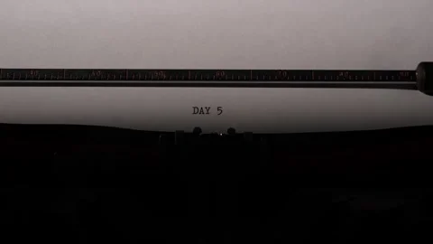 Vintage mechanical typewriter typing day 5 on a white paper document Stock Footage 322911617