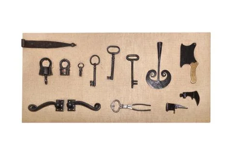 Vintage metal objects lying on the rough fabric, isolated on white Stockfoto's