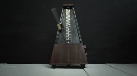Vintage metronome, on a dark background. 库存影片 60578426