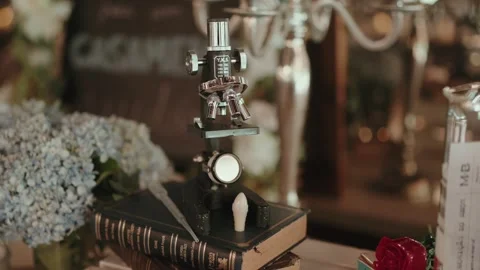Vintage Microscope on Books with Flowers Stock Footage 316367967