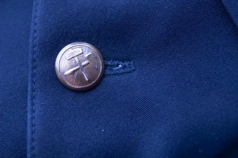 Vintage Mining Button with Crossed Hammers on Blue Uniform Stock Photos