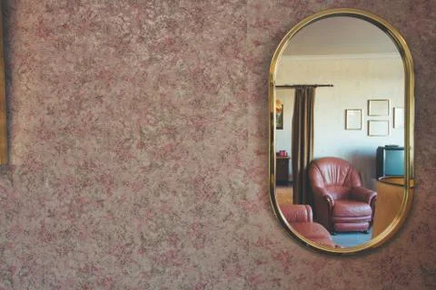 Vintage mirror with patterned wallpaper and a antique livingroom visible in the Stock Photos