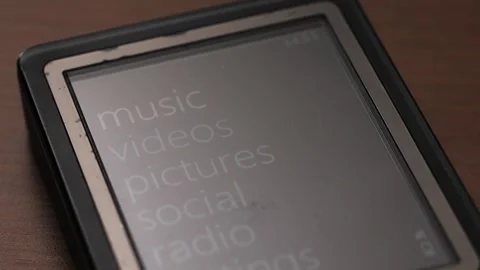 Vintage MP3 Player Scrolling Main Menu On Desk 動画素材 324795600
