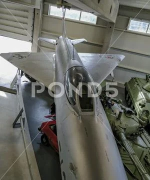 Vintage museum war combat jet airplane painted in silver color. Stock Photos