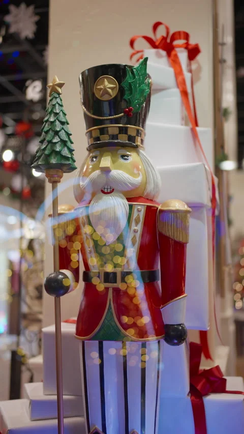 Vintage nutcracker soldier surrounded by holiday packages and warm Stock Footage 321302906
