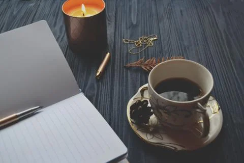 Vintage objects and a cup of coffee on the wooden table. Stock Photos