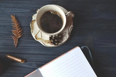Vintage objects and a cup of coffee on the wooden table. Stock Photos
