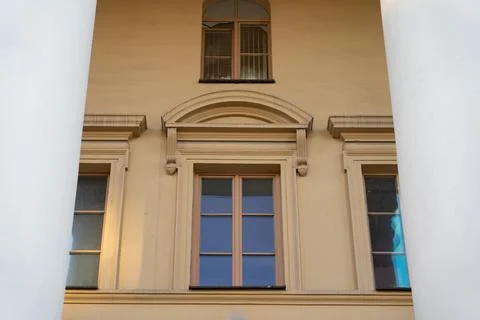 Vintage, old building. Windows between the columns. Framing Stock Photos