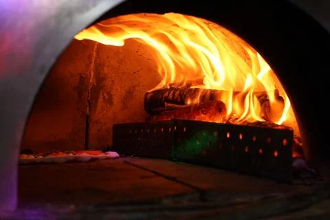 Vintage old Oven with fire inside for baking Original Pizza. Stock Photos
