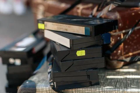 Vintage old videotapes VHS in a stack lie on the TV Stock Photos