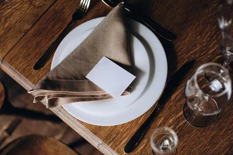 Vintage or rustic wedding table setting in restaurant. Elegant empty white pl Stock Photos