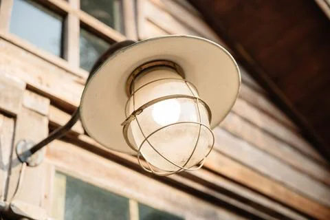 Vintage outdoor street or front door light bulb with weather protection roo.. Stock Photos