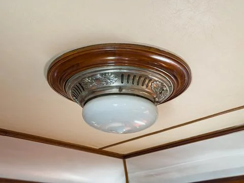 Vintage passenger train interior featuring luxurious ceiling light fixture,.. Stock Photos