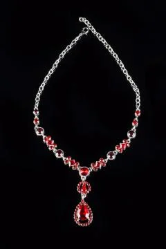 Vintage pendant with ruby and crystals on   black background Stock Photos