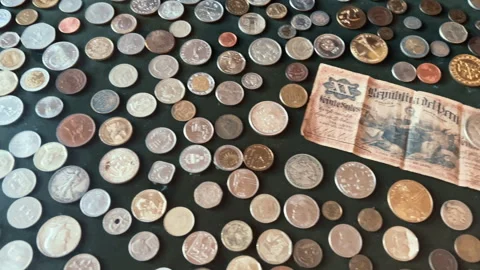 Vintage Peruvian Banknote and Diverse International Coin Collection Stock Footage 339713631