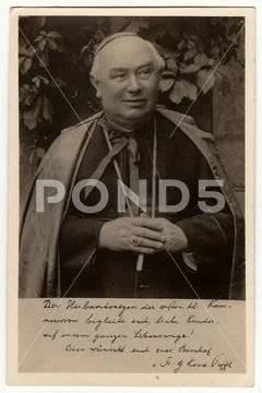 Vintage photo shows a catholic priest. Black & white antique photography. Stock Photos