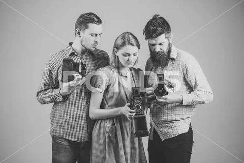 Vintage photography. Men, woman on interested faces looks at camera on grey Stock Photos