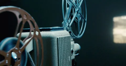 Vintage Projector Casting Bright Beam In Room Full Of Cinematic History Vibes Stock Footage 315352078