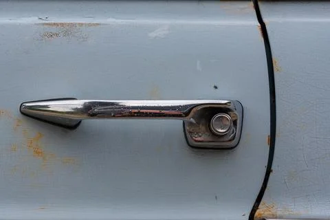 Vintage push button door styled handle on a light blue car Photos
