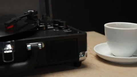 Vintage record player with a cup of coffee on a wooden table Video stock 340844744